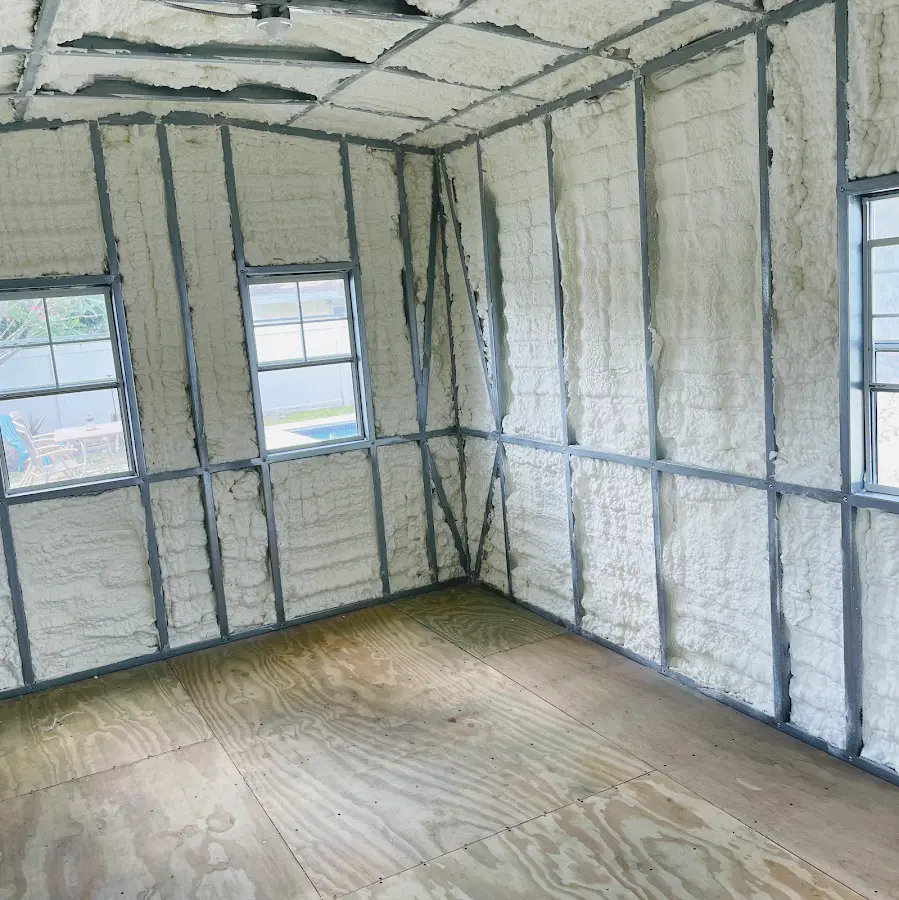 Closed-cell spray foam insulation applied to wall cavities in a residential project in Sudley